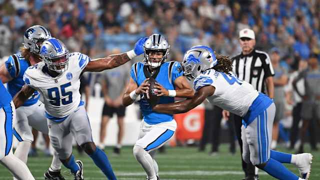 Detroit Lions defensive ends Romeo Okwara and James Houston pursue Carolina quarterback Bryce Young.